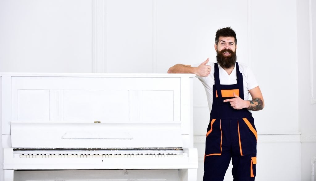 Man giving thumbs up after moving piano